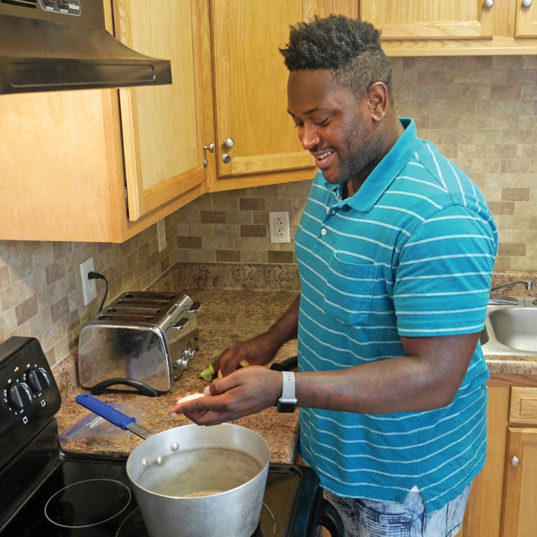 A man cooks in a kitchen