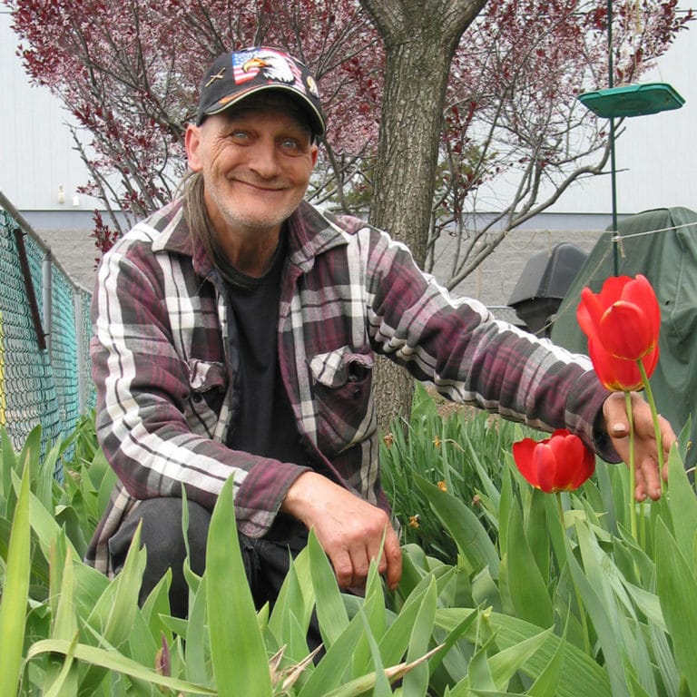 A Rescue Mission patron in a garden